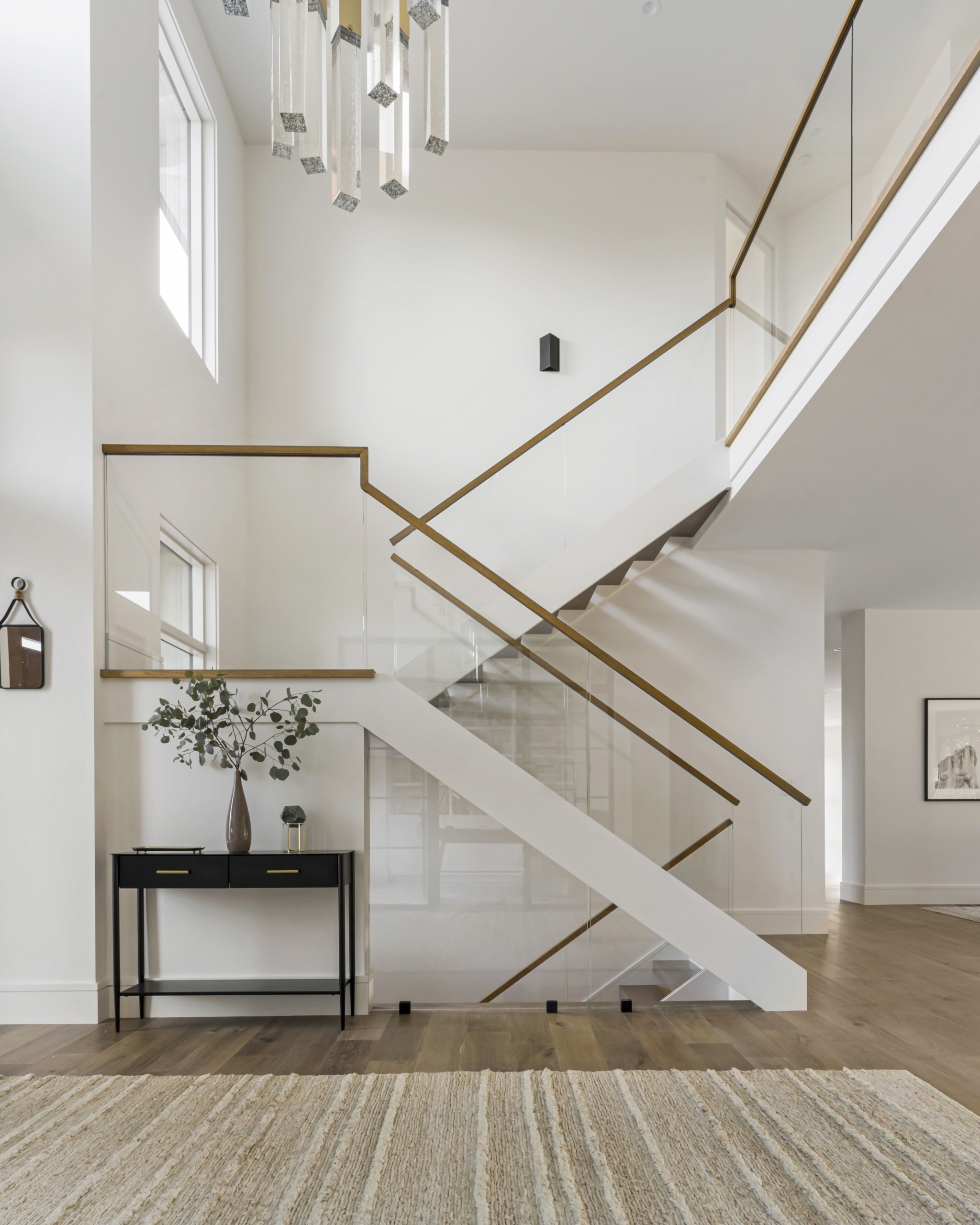 Bright white staircase with glass railing